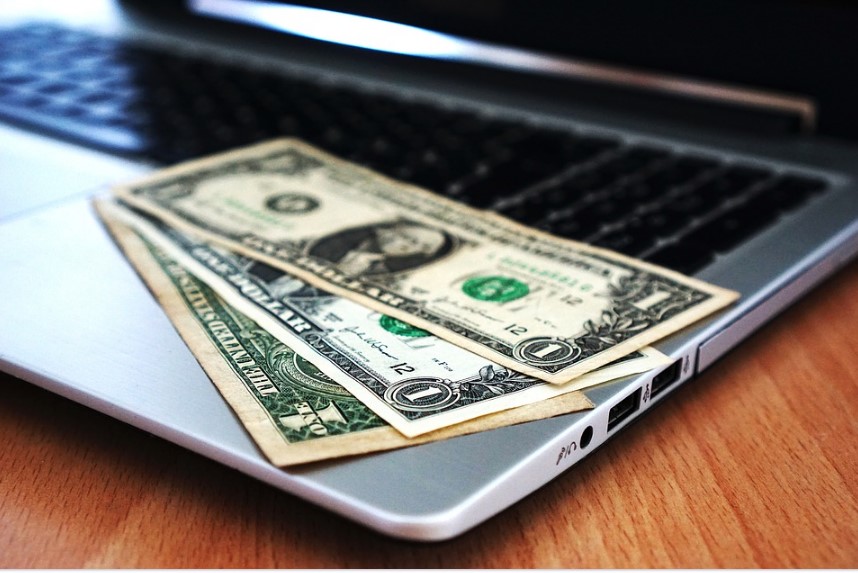 1 dollar bills on a laptop